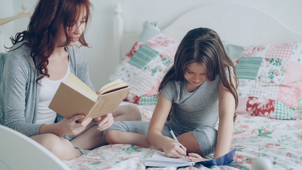 A mother helping her daughter with homework at home