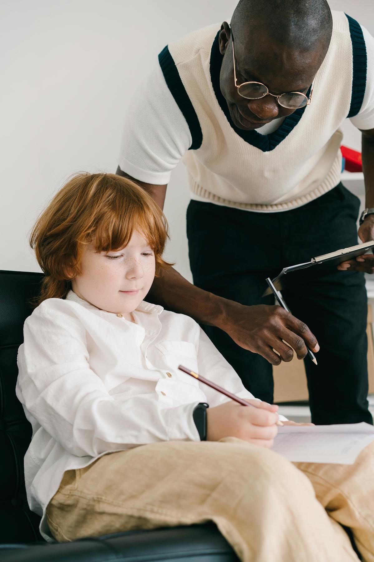 A tutor helping a child with math homework during a learning session