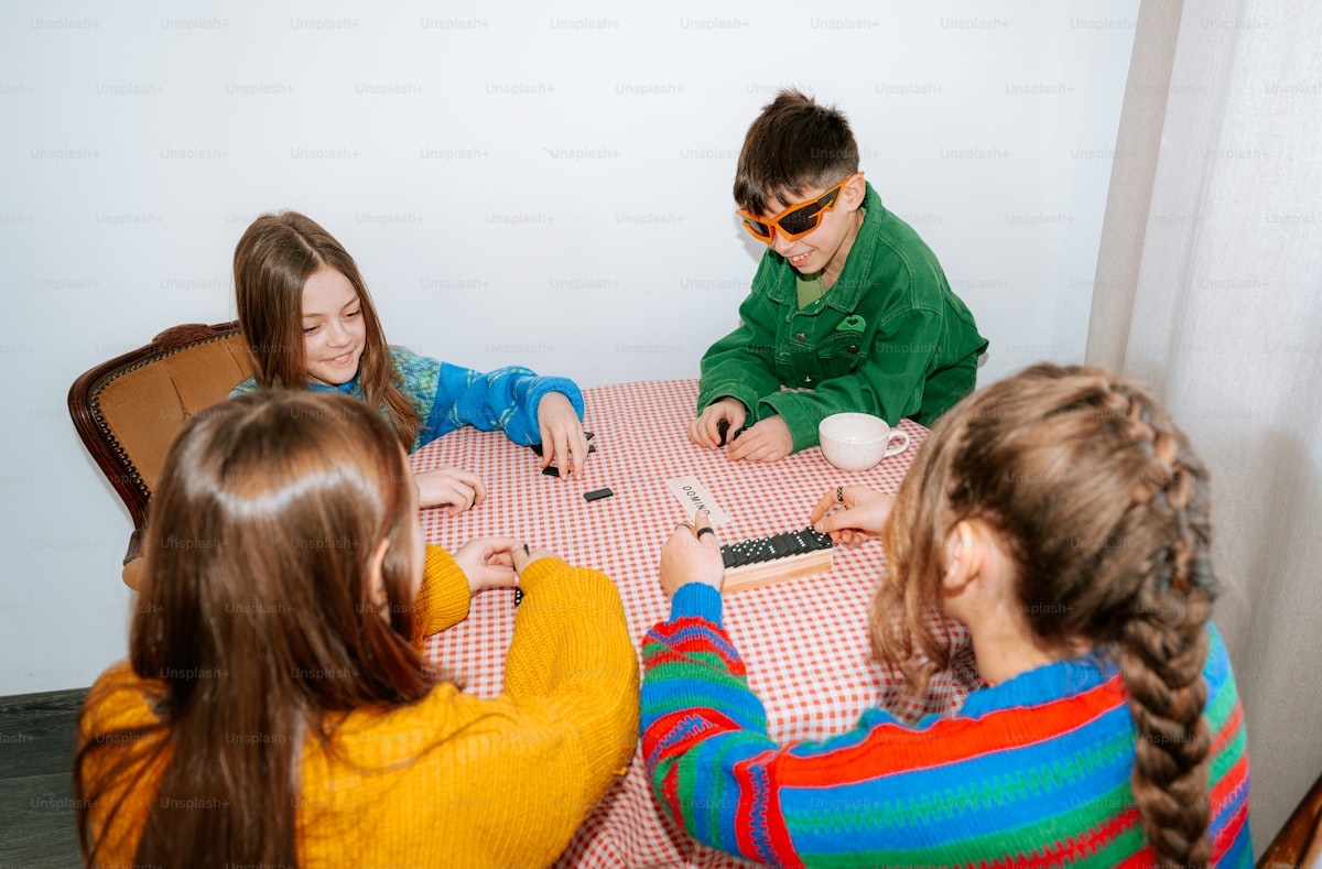 Children gathered around a table playing a game together